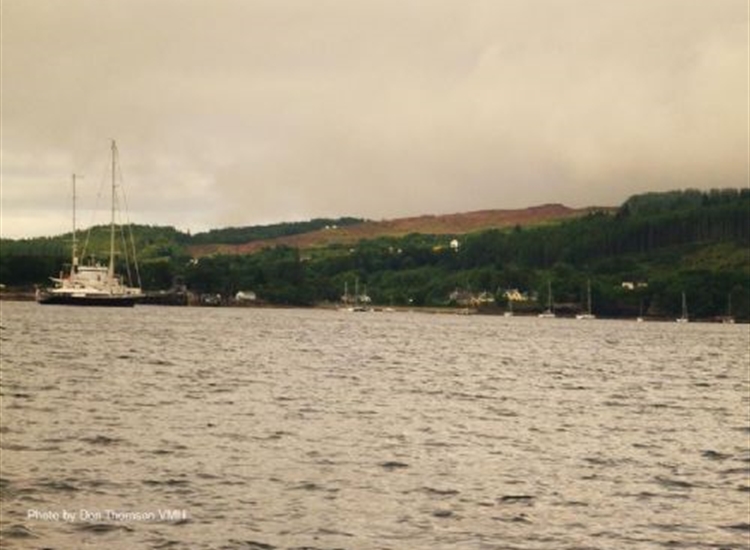 Approach to Armadale. CalMac pier behind large yacht on port bow. Anchorage dead ahead