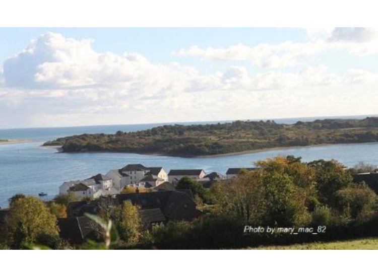 Dundrum. Entrance on left. Boat at anchor bottom left